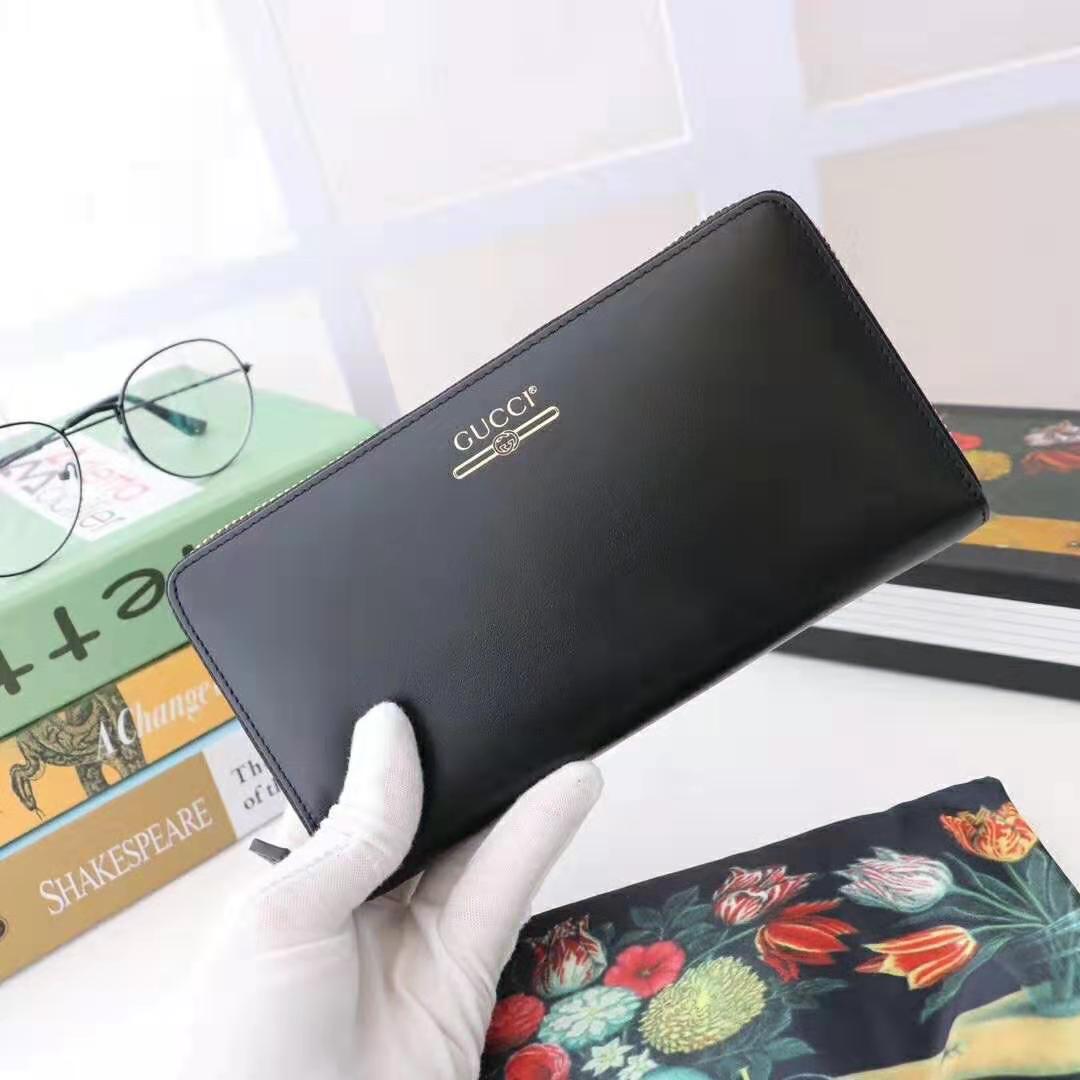 G*u*i gg unisex leather zip around wallet with G*u*i logo in black leather